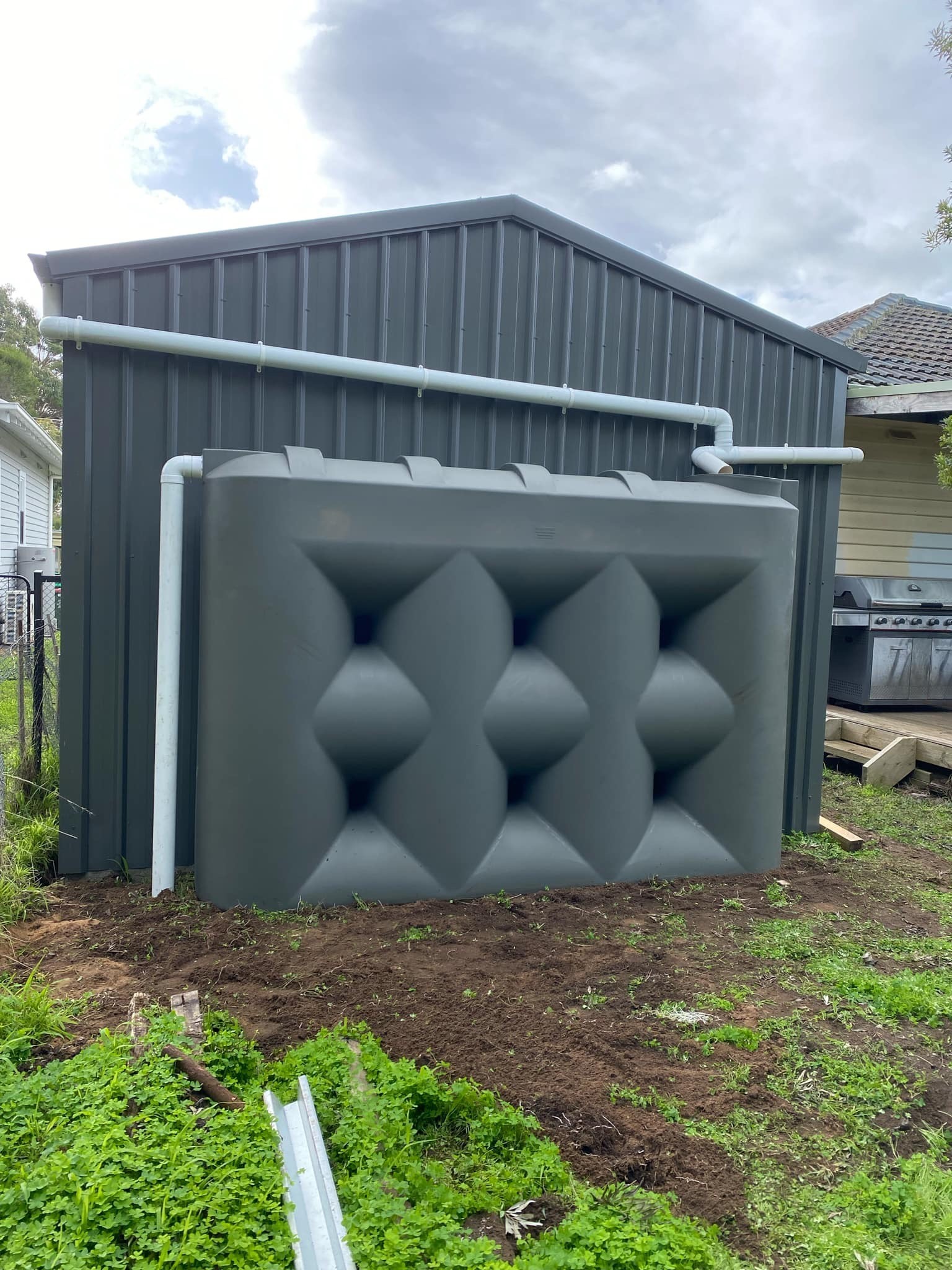 Rainwater tank plumbed into stormwater pipework off a Colorbond shed